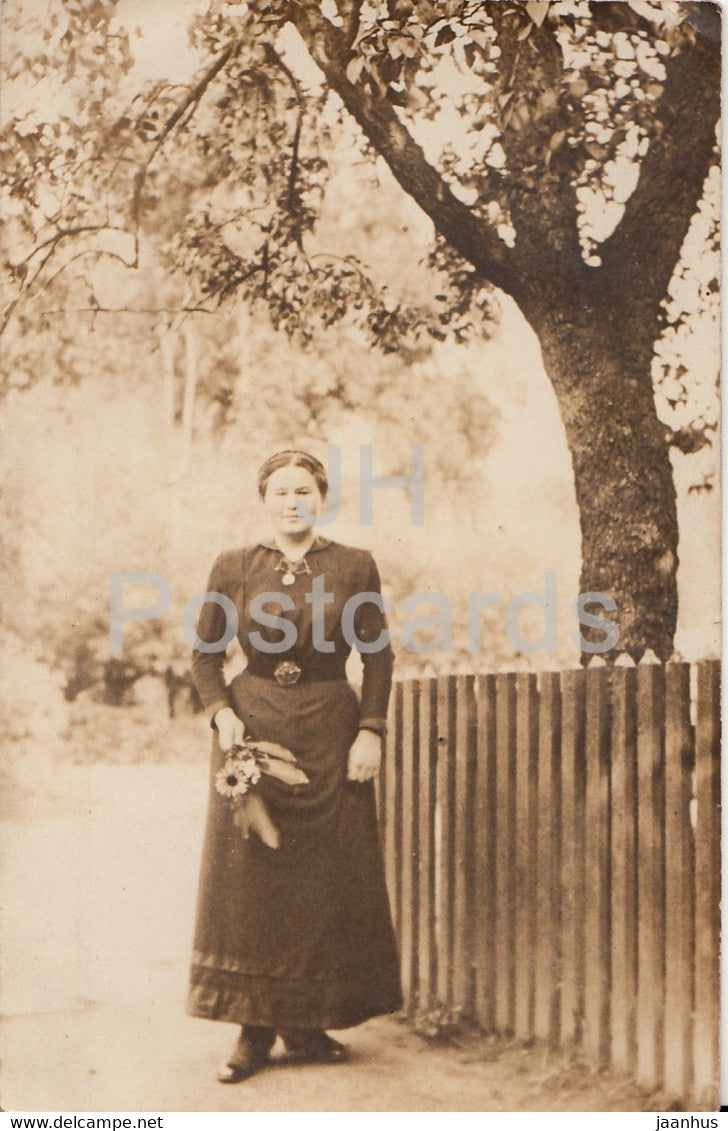 woman by the fence - old postcard - Germany -  unused - JH Postcards